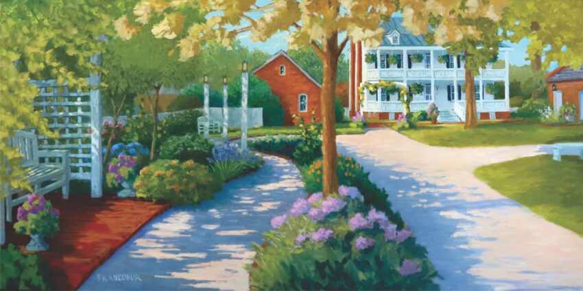 Two flower lined walking paths surrounded by flowers and lush shrubs leading to two-story old white home