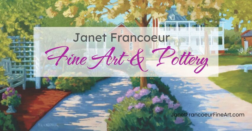 Two flower lined walking paths surrounded by flowers and lush shrubs leading to two-story old white home