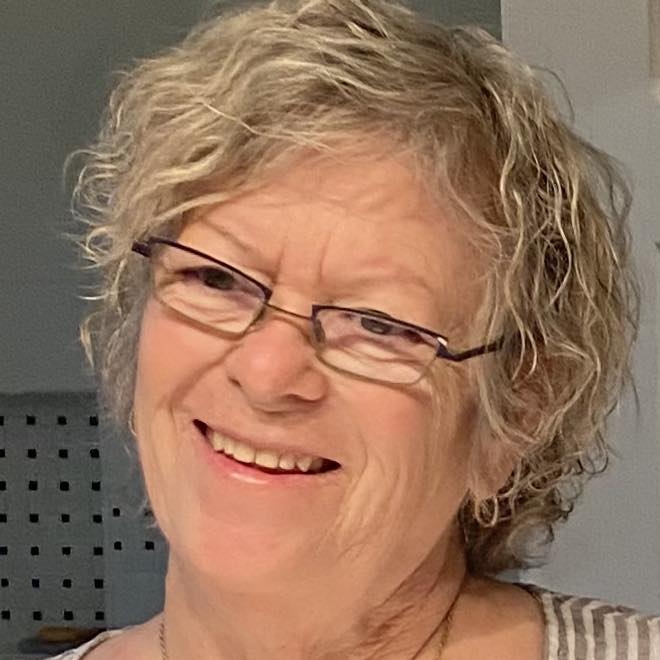 Blonde woman with short hair wearing glasses