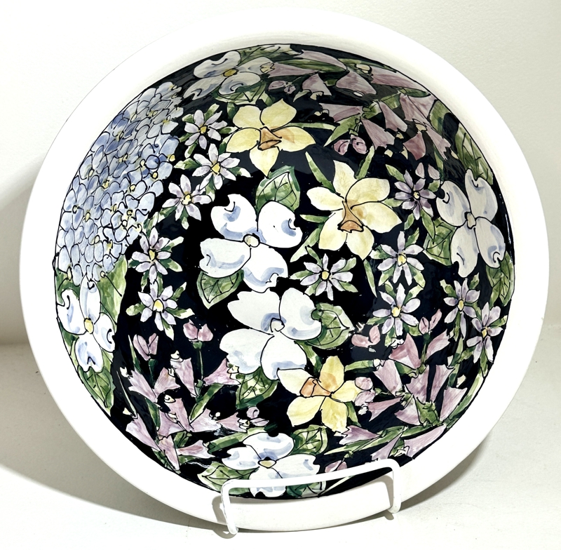 Bowl with dark background with white and purple flowers